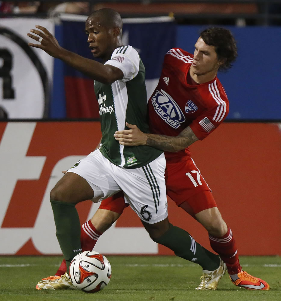 FC Dallas defender Zach Loyd (17) tries to get around the Portland Timbers forward Darlington Nagbe (6) during the first half of their match at Toyota Stadium in Frisco, Texas on Saturday, Oct. 25, 2014. (AP Photo/The Dallas Morning News, Stewart F.