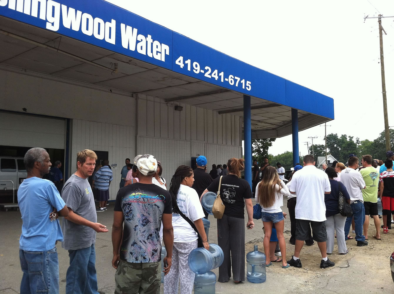 Residents line up for water Saturday in Toledo, Ohio.