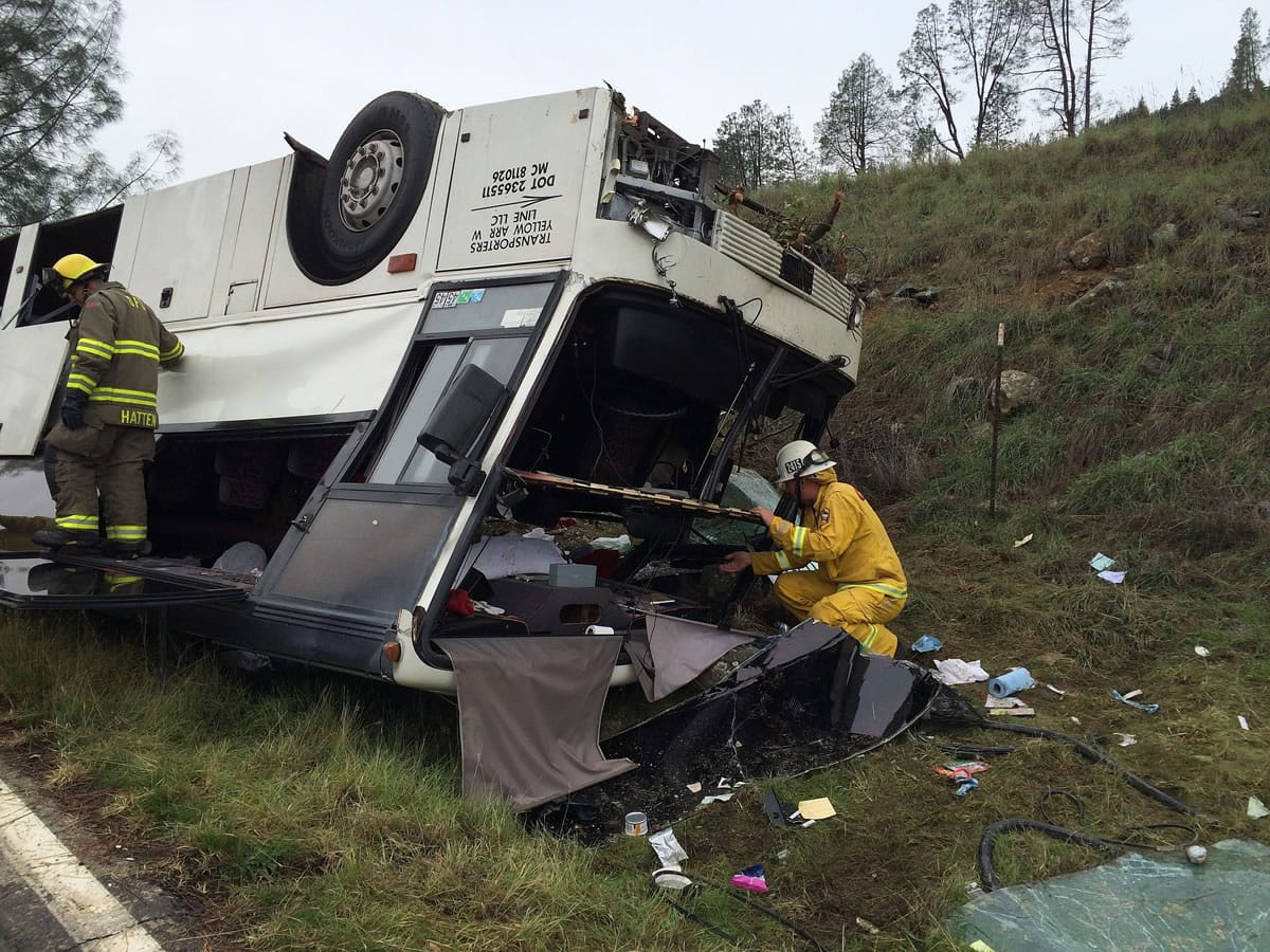 Emergency personnel check a tour bus that had already crashed earlier in the day overturned just off Interstate 5 in Northern California, killing one person and sending dozens to hospitals near the Pollard Flat area in Redding, Calif., on Sunday.