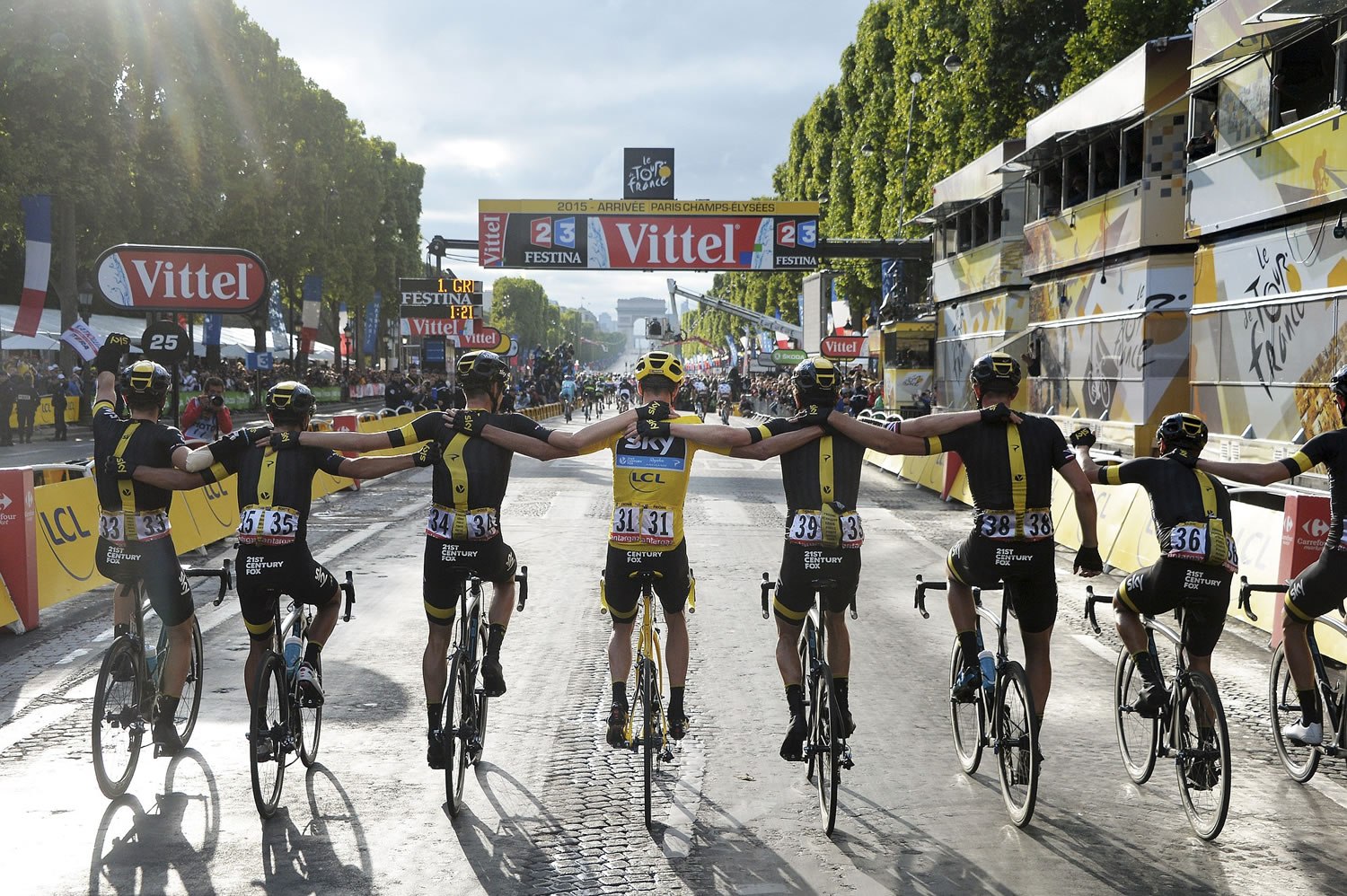 Team Sky with 2015 Tour de France cycling race winner Chris Froome of Britain, wearing the overall leader's yellow jersey, crosses the finish line of the 21st and last stage of the Tour de France in Paris, France, on Sunday, July 26, 2015.