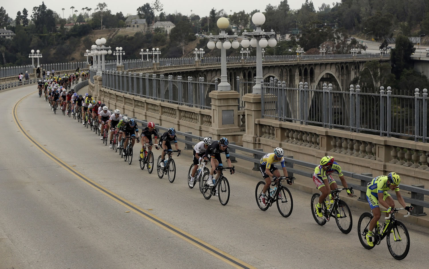 The peloton crosses the Colorado Street Bridge on the final stage of the Amgen Tour of California cycling race from Los Angeles to Pasadena on Sunday in Pasadena, Calif.