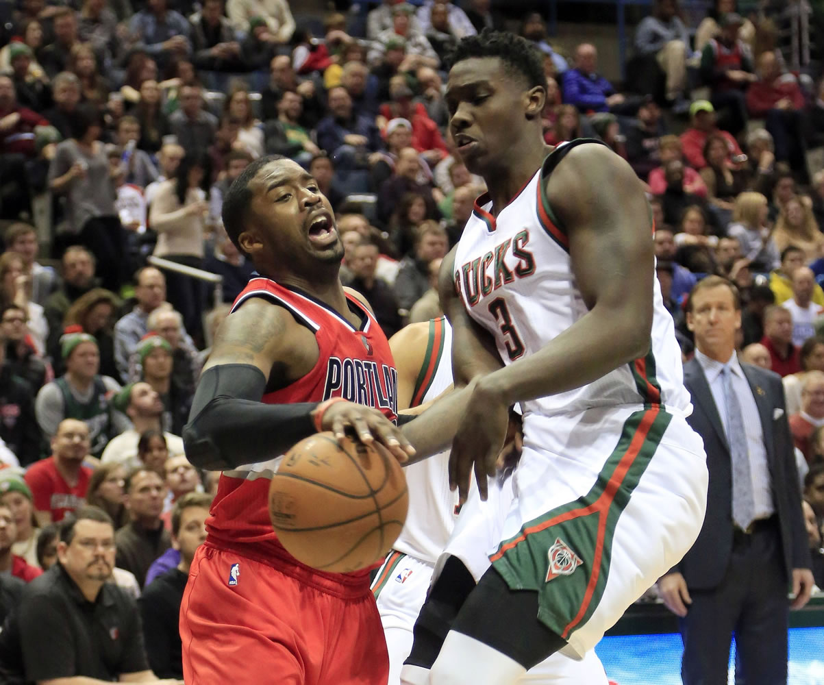 Portland Trail Blazers guard Wesley Matthews, left, is fouled by Milwaukee Bucks forward Johnny O'Bryant III, right, during the first half Saturday, Jan. 31, 2015, in Milwaukee.
