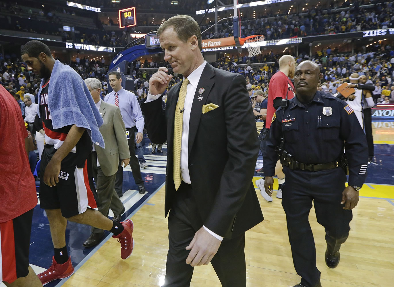 Portland Trail Blazers head coach Terry Stotts leaves the court with forward LaMarcus Aldridge, left, after losing to the Memphis Grizzlies in Game 5 of an NBA basketball Western Conference playoff series Wednesday, April 29, 2015, in Memphis, Tenn. The Grizzlies won 99-93 to win the series 4-1.