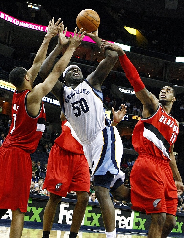 Memphis' Zach Randolph (50) is fouled by Portland's LaMarcus Aldridge, right, as Brandon Roy, left, defends during the second half in Memphis, Tenn., on Monday.