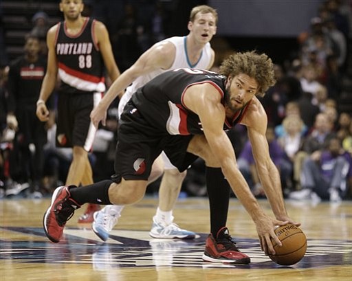 Portland Trail Blazers' Robin Lopez (42) grabs a loose ball against the Charlotte Hornets during the second half Wednesday in Charlotte, N.C.