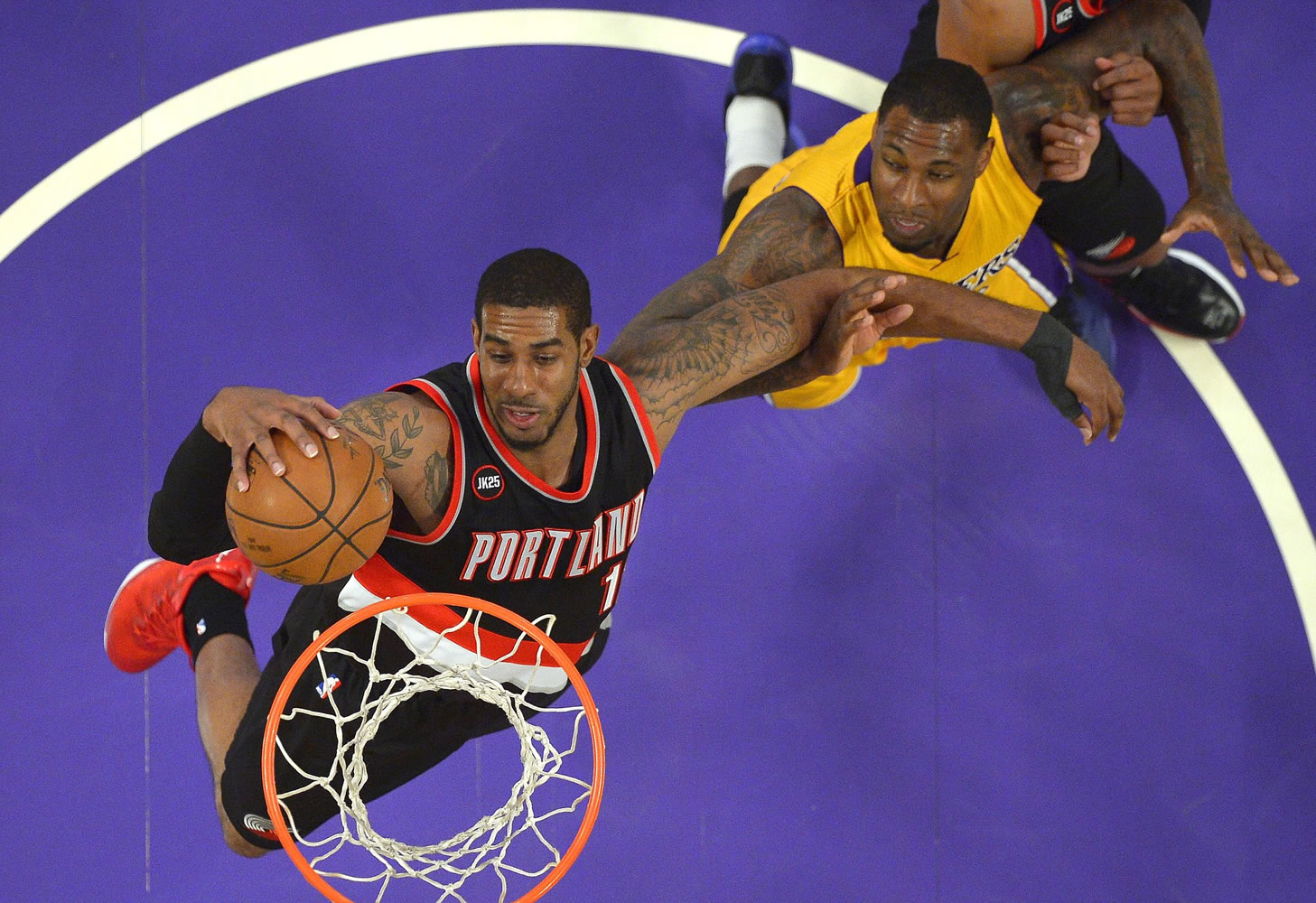 Portland Trail Blazers forward LaMarcus Aldridge, left, grabs a rebound away from Los Angeles Lakers forward Tarik Black during the first half of an NBA basketball game, Friday, April 3, 2015, in Los Angeles. (AP Photo/Mark J.