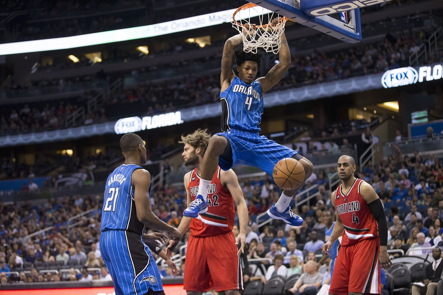 Orlando Magic guard Elfrid Payton (4) dunks on Portland Trail Blazers Robin Lopez (42) and Arron Afflalo (4) during the first half in Orlando, Fla., on Friday.