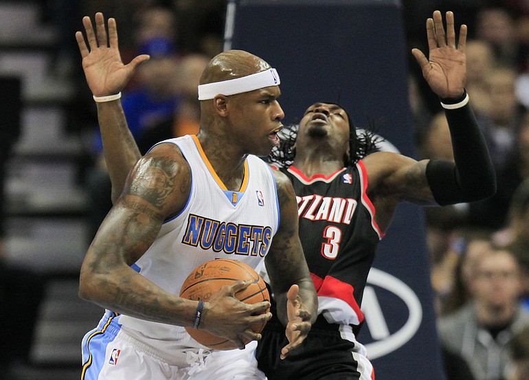 Denver Nuggets power forward Al Harrington, left, knocks Portland Trail Blazers small forward Gerald Wallace (3) off his feet while driving to the basket during the second quarter of an NBA basketball game on Wednesday, Feb. 29, 2012 in Denver.