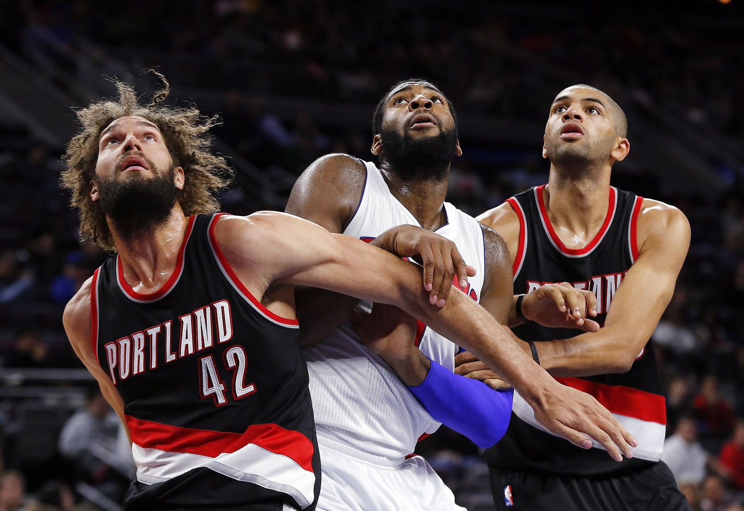 Portland Trail Blazers center Robin Lopez (42) and forward Nicolas Batum, right, block out Detroit Pistons center Andre Drummond, center, in the second half Tuesday.