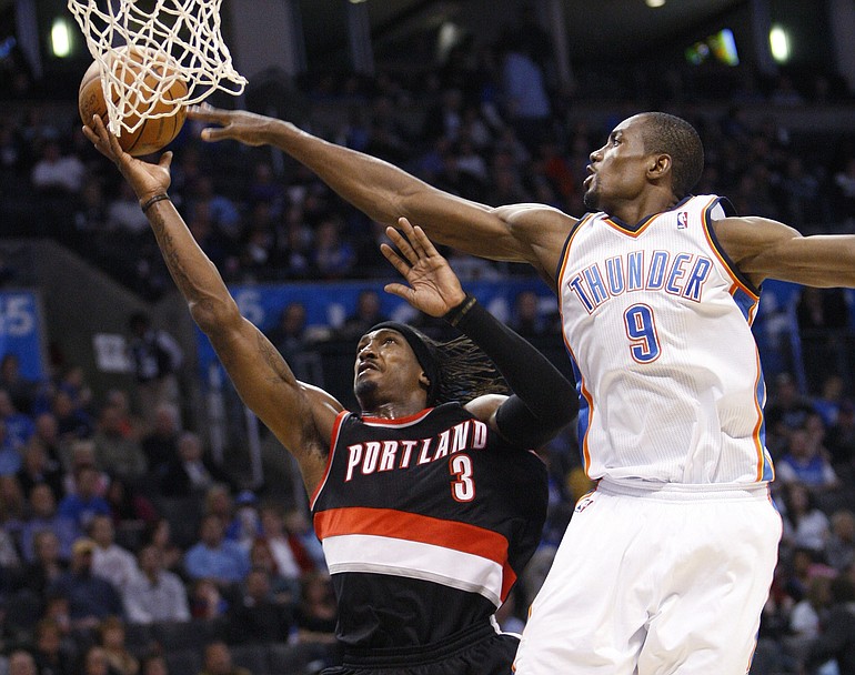 Portland Trail Blazers forward Gerald Wallace, left, shoots in front of Oklahoma City Thunder forward Serge Ibaka during the second quarter Sunday.