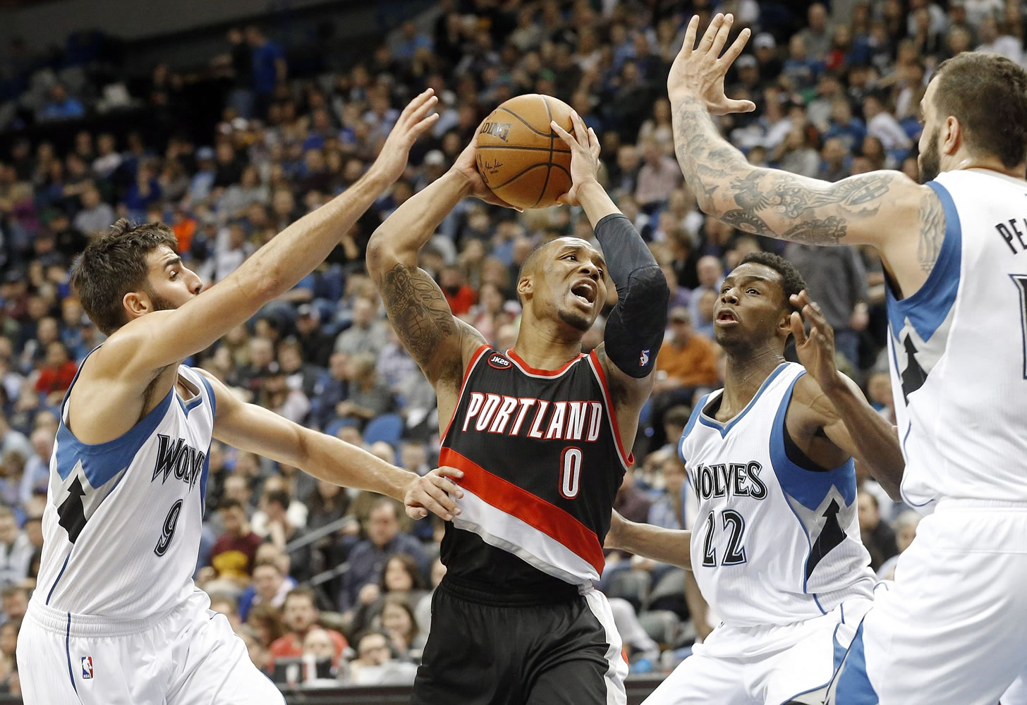 Portland Trail Blazers' Damian Lillard (0) finds himself triple-teamed by Minnesota Timberwolves' Ricky Rubio, left, Andrew Wiggins (22) and Nikola Pekovic, in the second half Saturday, March 7, 2015, in Minneapolis. The Timberwolves won 121-113. Lillard led the Trail Blazers with 32 points.