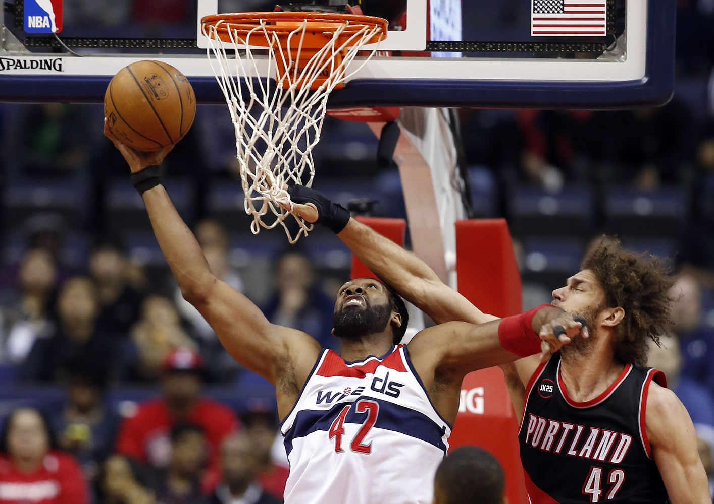 Washington Wizards forward Nene (42), from Brazil, shoots as Portland Trail Blazers center Robin Lopez (42) defends in the first half of an NBA basketball game Monday, March 16, 2015, in Washington.