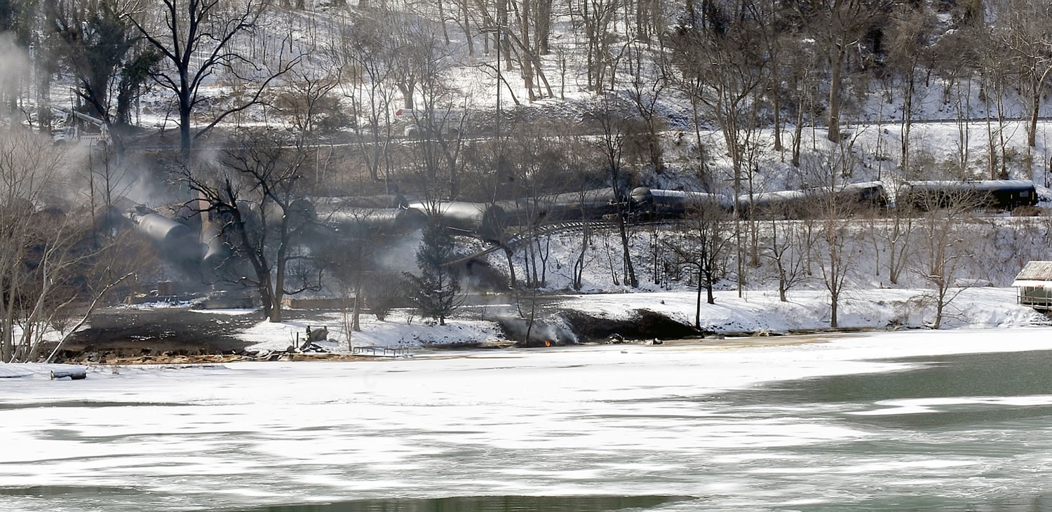 A train derailment that sent a tanker with crude oil into the Kanawha River on Monday was still smoldering Tuesday near Mount Carbon, W.Va. Fires burned for hours after the train carrying more than 100 tankers of crude oil derailed, sending a fireball into the sky and threatening the water supply of nearby residents, authorities and residents said Tuesday. Officials evacuated hundreds of families and shut down two water treatment plant following the Monday afternoon derailment.