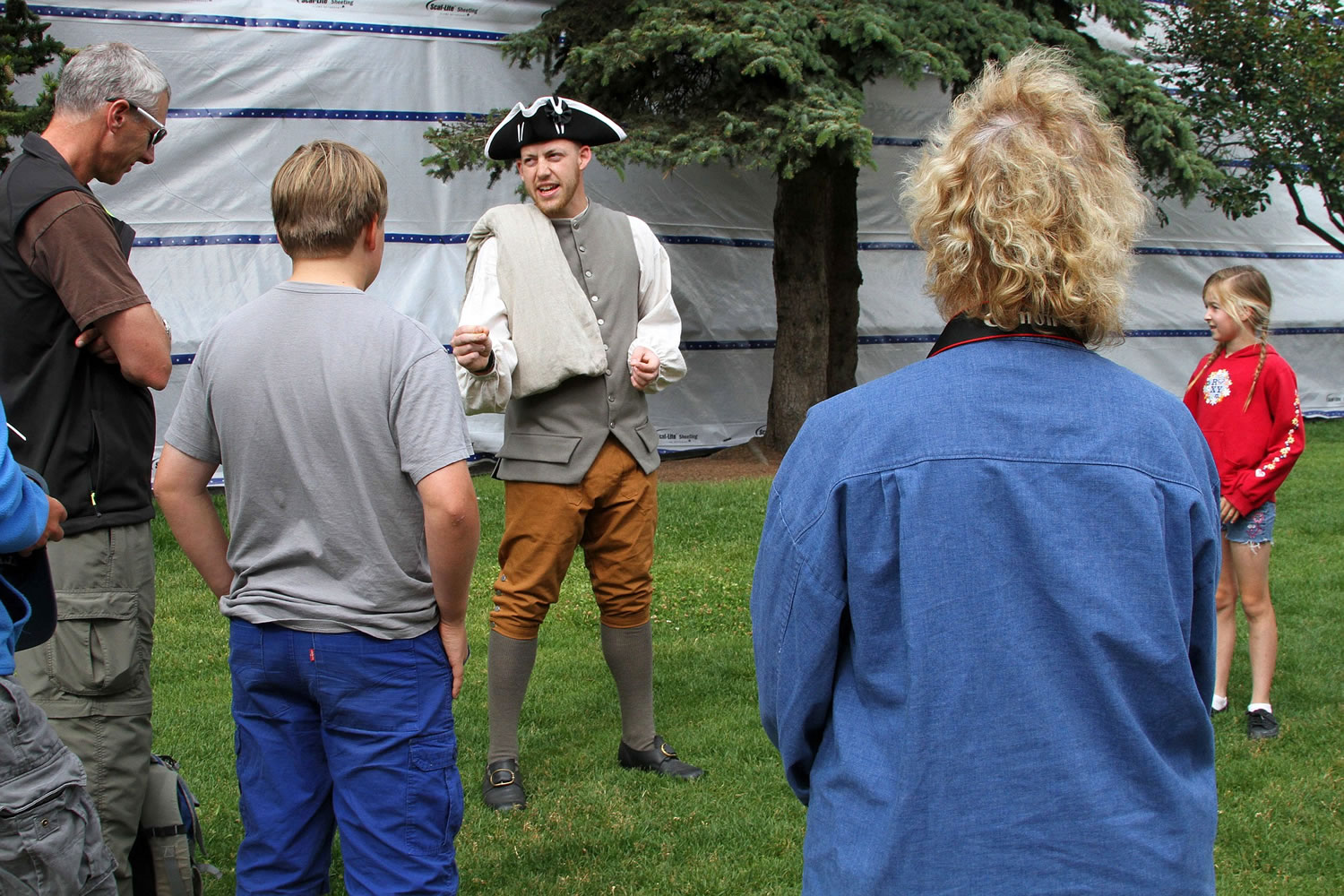 This photo taken July 8, 2014, shows Cameron Sanders with the National Park Service, center, at the start of a walking tour of Captain Cook sites from the Alaska Public Lands Information Center in downtown, Anchorage, Alaska. The center is a clearinghouse for state and federal land in the nation's largest state.