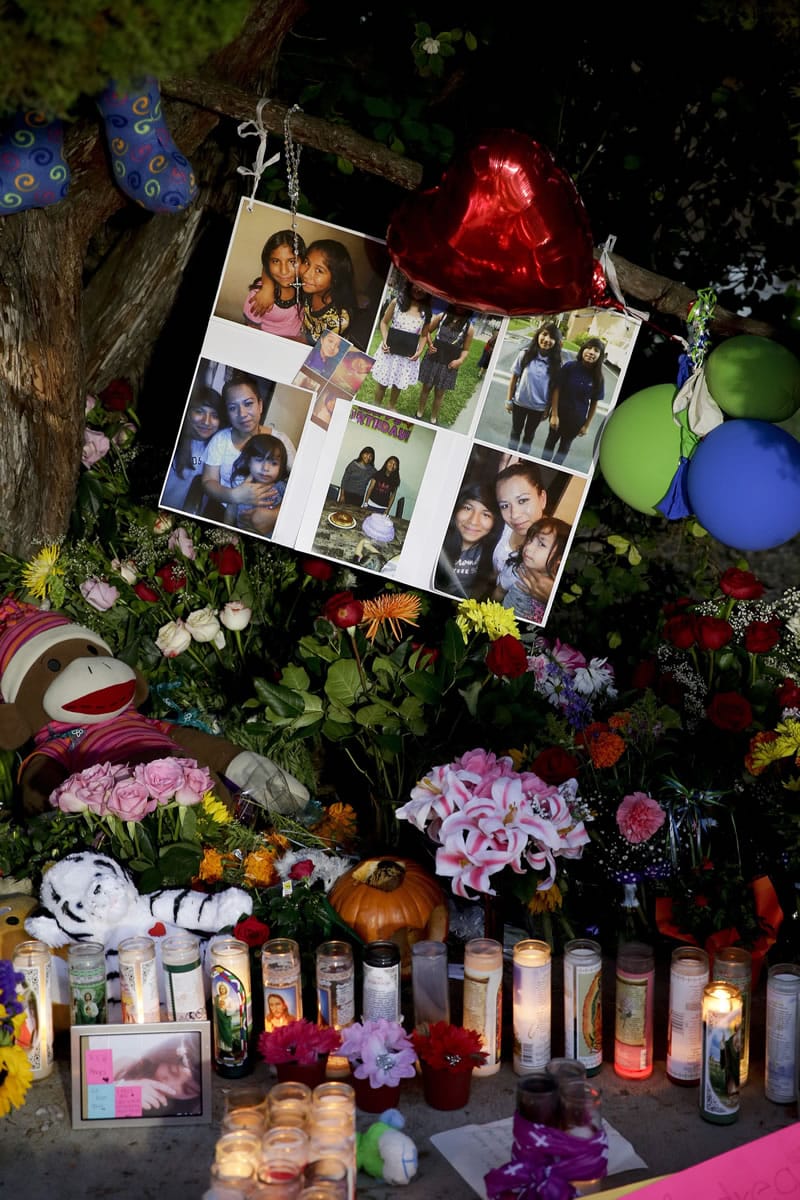 Photographs of twin sisters Lexi and Lexandra Perez are displayed Monday at a makeshift memorial near where they and Andrea Gonzales were killed in a hit and run on Halloween in Santa Ana, Calif.