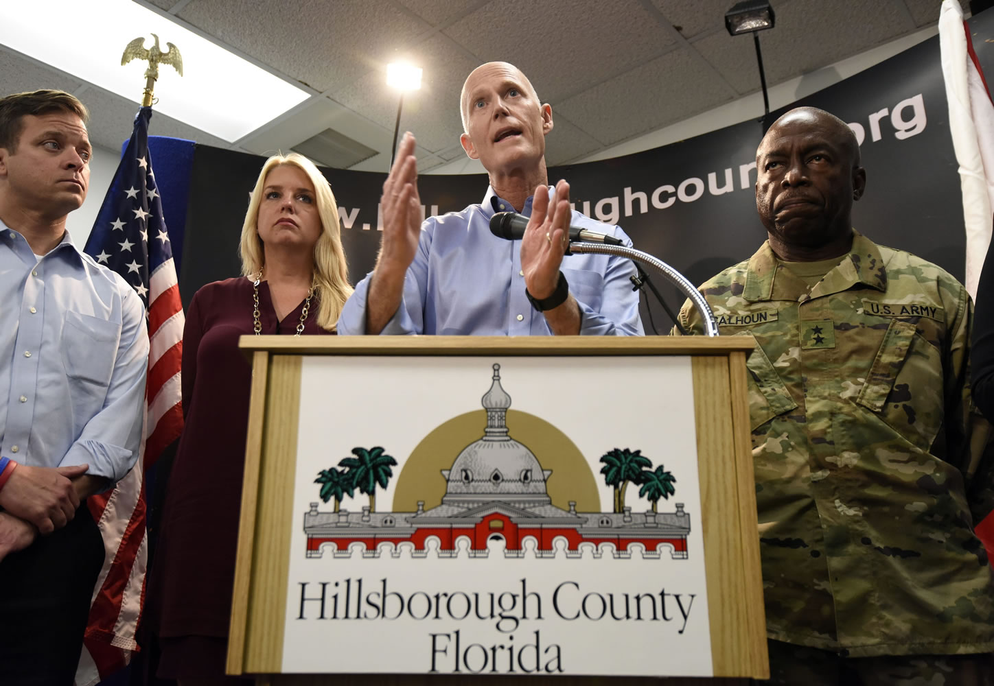 Gov. Rick Scott speaks accompanied by Florida Attorney General Pam Bondi, Lt. Gov. Carlos Lopez-Cantera, left, and Maj. General Michael Calhoun, right, during a news conference at the Hillsborough County Emergency Operations Center in Tampa, Fla. on Friday, Aug. 28, 2015. The governor and several local officials were on hand at the county E.O.C. to discuss Tropical Storm Erika and its possible impact on the state. (Chris Urso/The Tampa Tribune via AP)  ST.