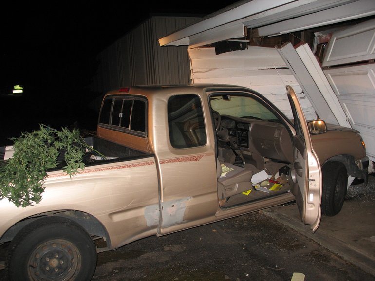 This truck was allegedly stolen by two medical marijuana burglary suspects. As the suspect fled from police, they crashed into a detached garage.