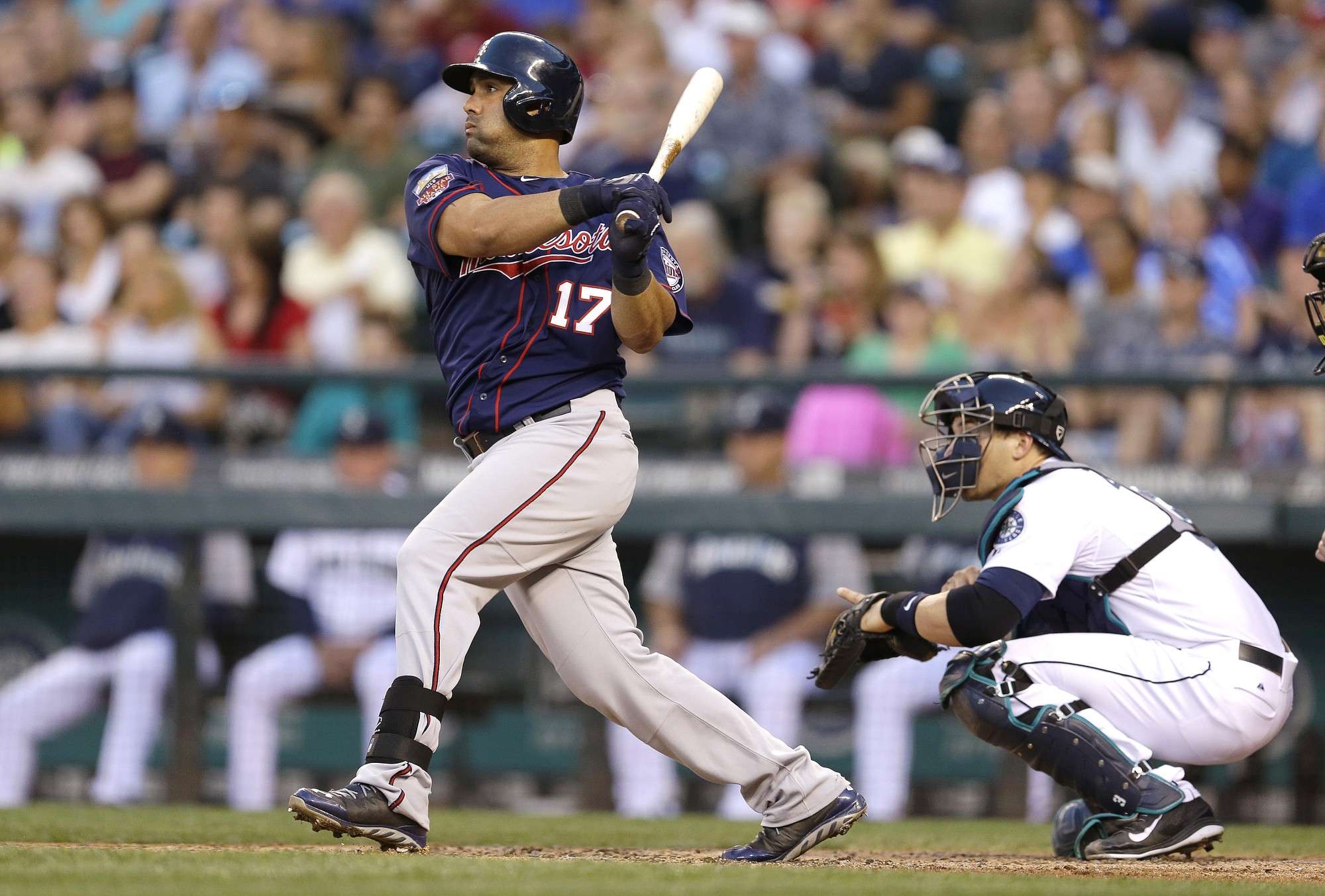 Minnesota Twins designated hitter Kendrys Morales (17) hits a two-run double in the fifth inning of a baseball game against the Seattle Mariners, Thursday, July 10, 2014, in Seattle. (AP Photo/Ted S.