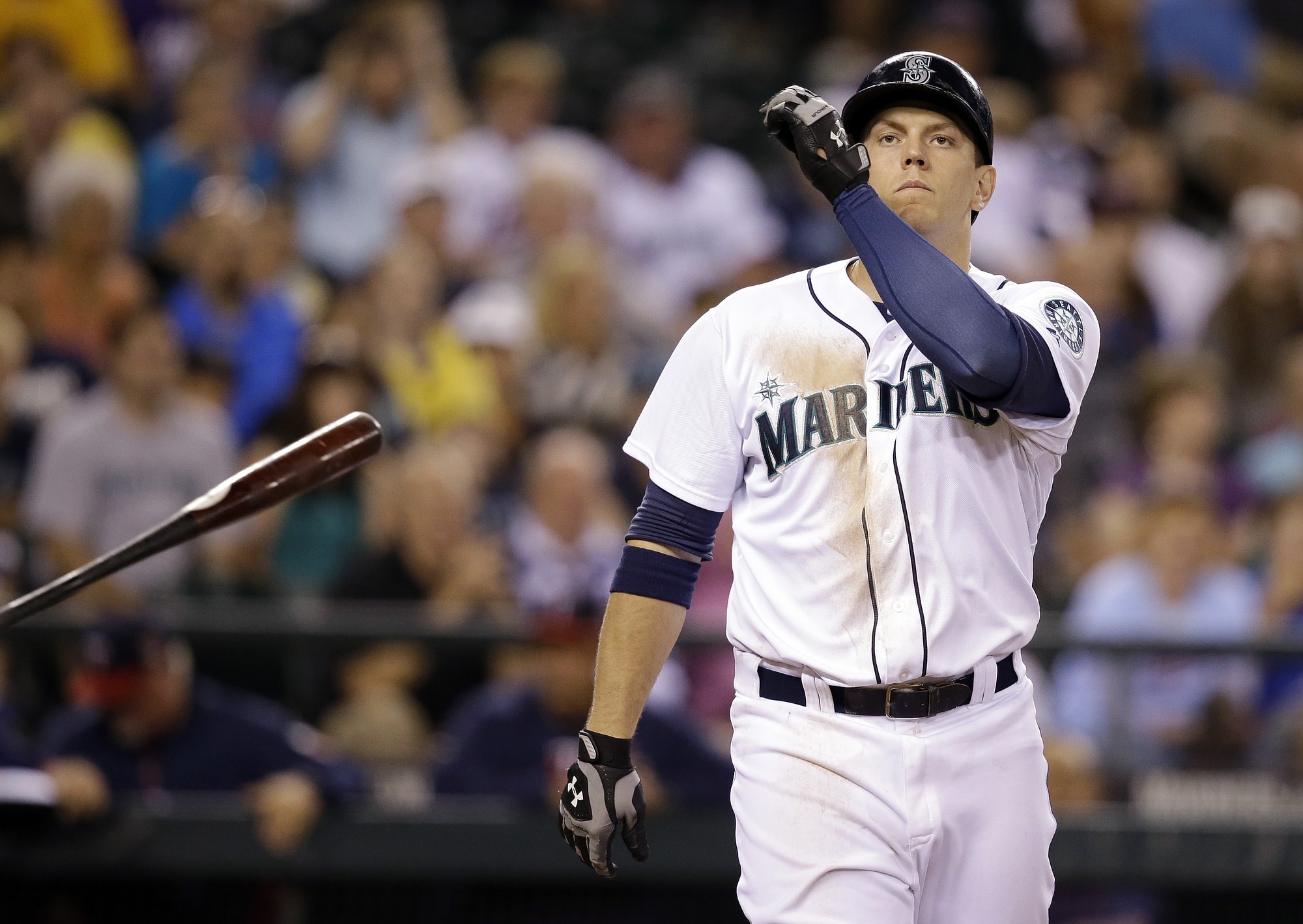 Seattle Mariners' Logan Morrison tosses aside his bat after striking out looking to end the seventh inning against the Minnesota Twins in a baseball game Wednesday, July 9, 2014, in Seattle.