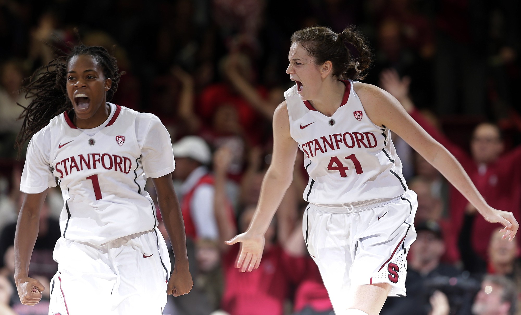Stanford forward Bonnie Samuelson (41) celebrates with teammate Lili Thompson (1) after Samuelson's three-point basket against Connecticut during the first half Monday, Nov. 17, 2014, in Stanford, Calif.