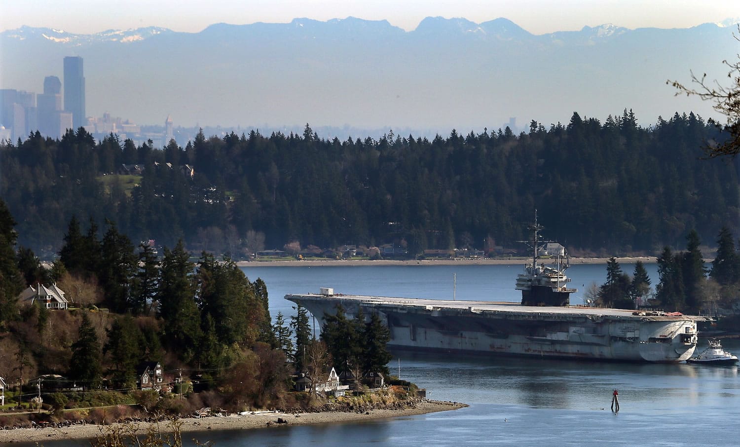The USS Ranger is towed through Rich Passage in Bremerton for the last time Thursday, as the historic aircraft carrier heads to Brownsville, Texas, to be dismantled.