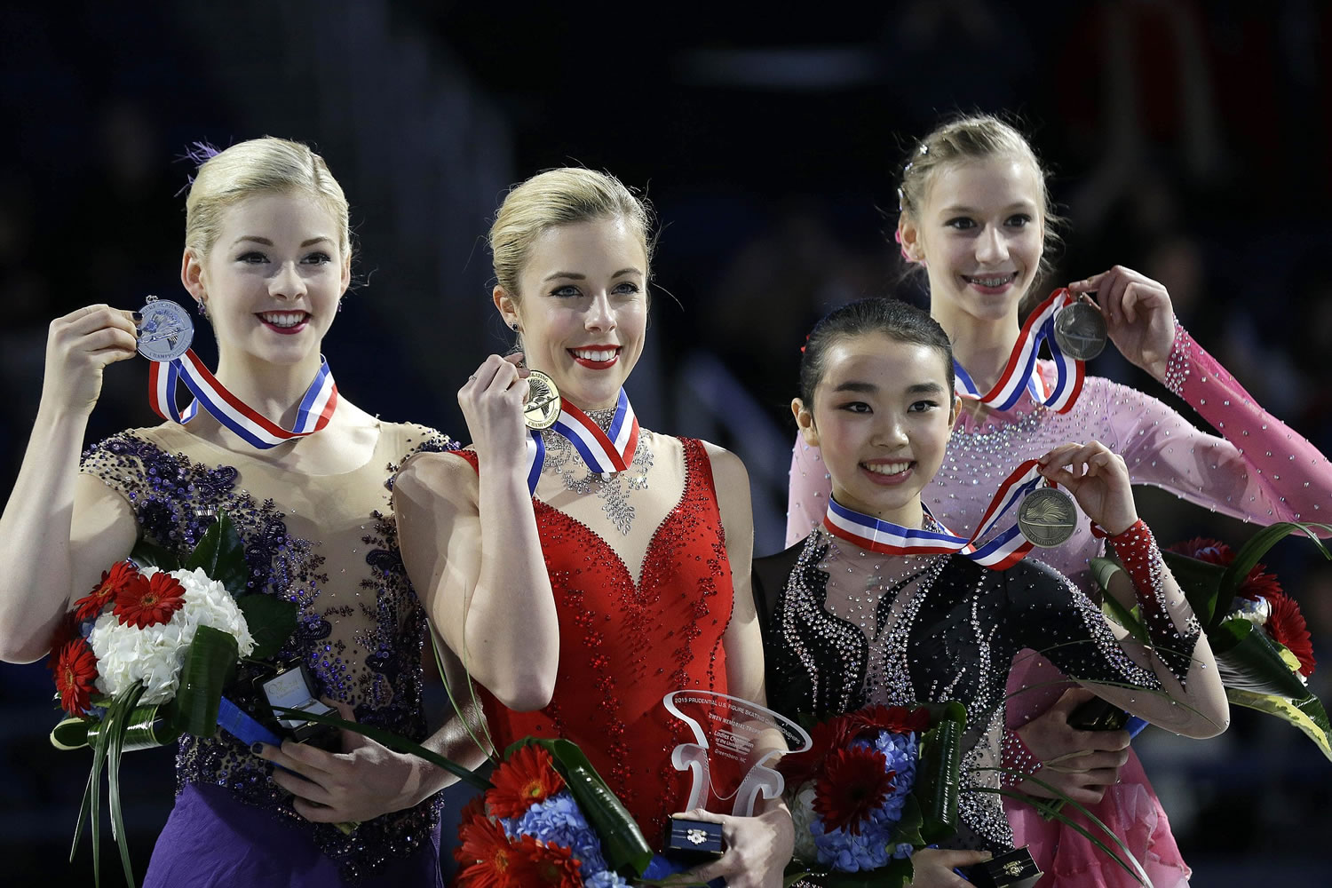 The top finishers of the women's competition, from left, Gracie Gold, second place; Ashley Wagner, first place; Karen Chen, third place; and Polina Edmunds, fourth place, hold their medals during the women's awards ceremony in the U.S. Figure Skating Championships in Greensboro, N.C., Saturday, Jan. 24, 2015.