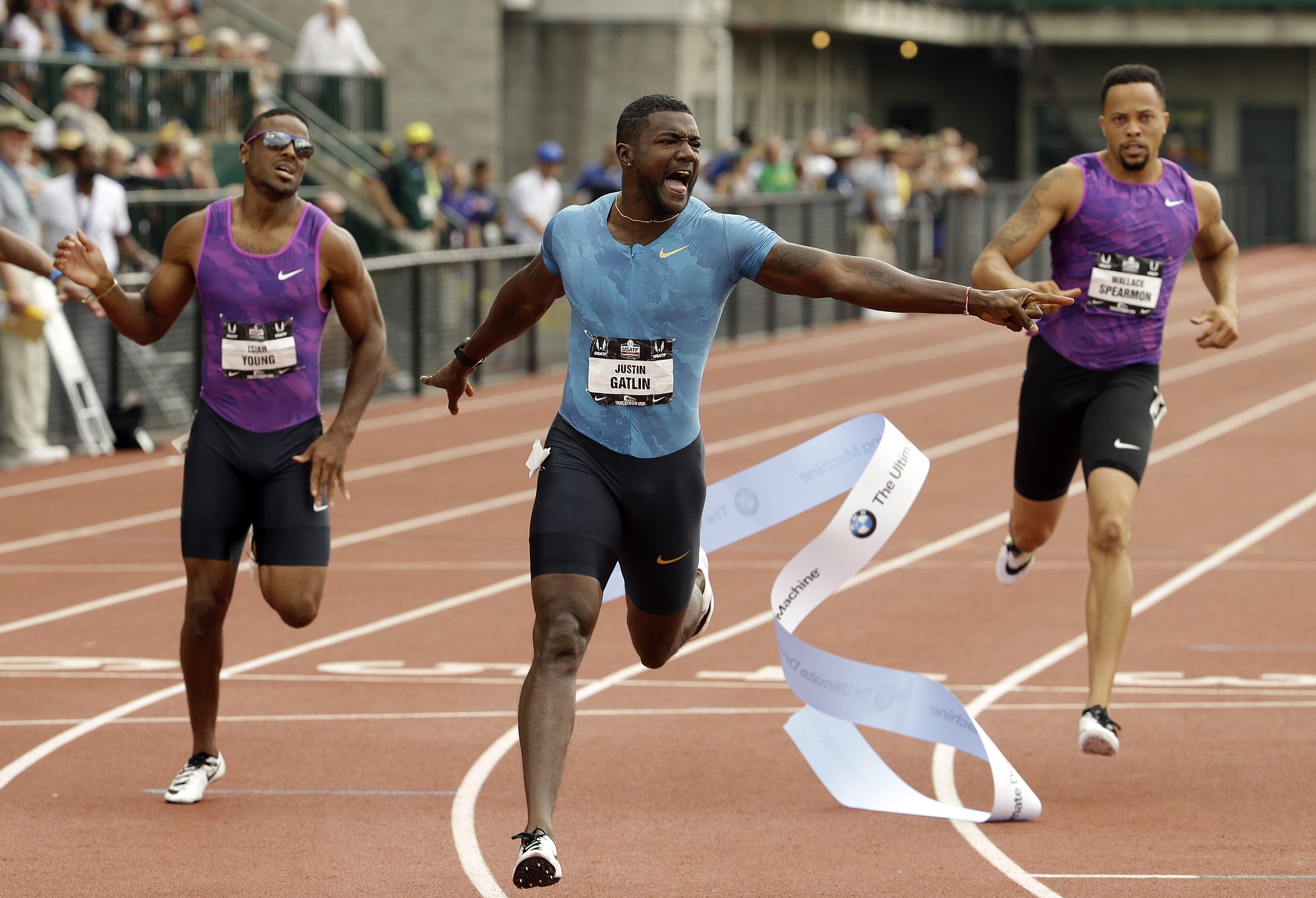 Justin Gatlin, center, wins the 200-meter ahead of Isiah Young, left, and Wallace Spearmon at the U.S. Track and Field Championships in Eugene, Ore., Sunday, June 28, 2015. Young finished second and Spearmon took third.
