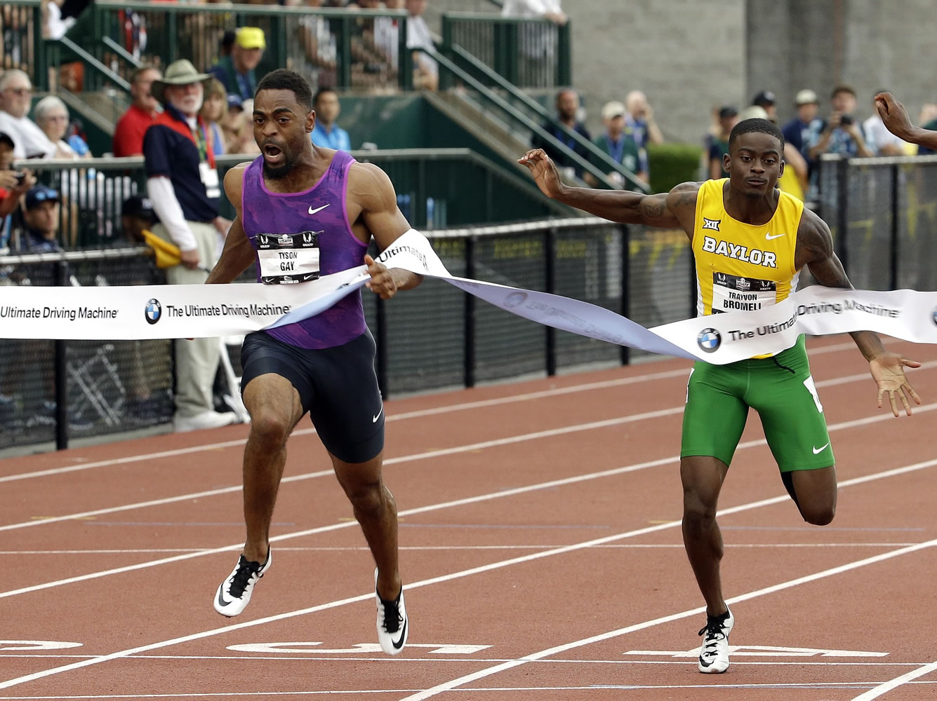 Tyson Gay, left, hits the tape ahead of Trayvon Bromell to win the 100-meter final at the U.S. Track and Field Championships in Eugene, Ore., Friday, June 26, 2015.