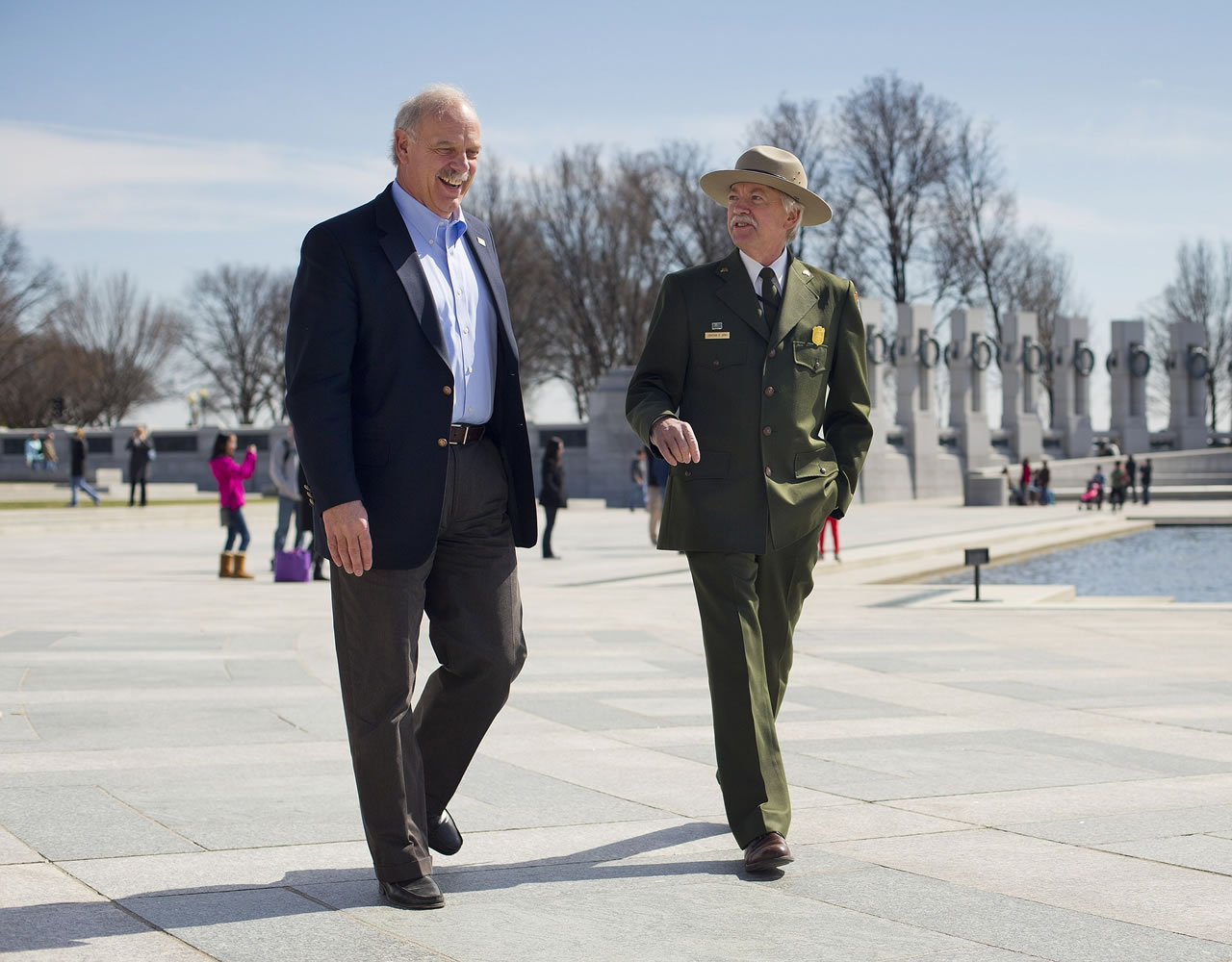 National Park Service Director Jonathan Jarvis, right, and the head of the National Park Foundation Dan Wenk walk at the World War II Memorial on the National Mall in Washington.