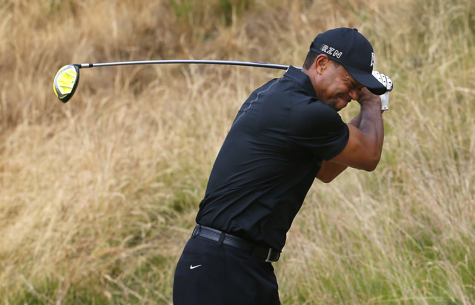 Tiger Woods reacts to his tee shot on the eighth hole during the first round of the U.S.