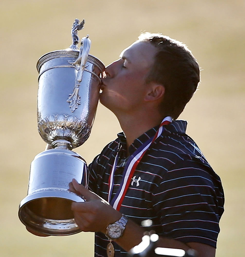 Jordan Spieth kisses the trophy after winning the the U.S. Open golf tournament at Chambers Bay on Sunday, June 21, 2015 in University Place.