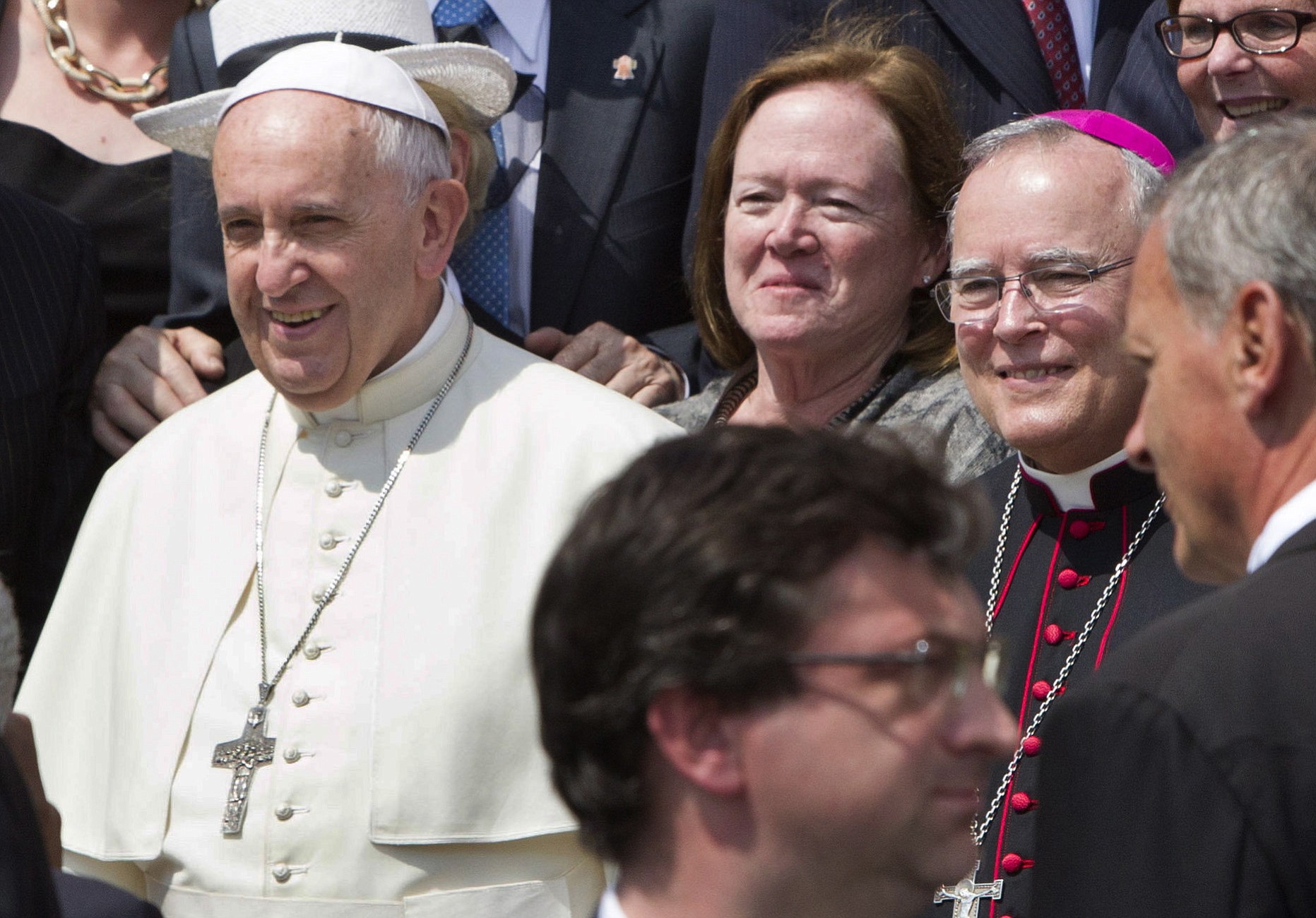 Philadelphia's Archbishop Charles Chaput, right, stands next to Pope Francis as they pose for a photo with a delegation from Philadelphia at the end of the pontiff's weekly general audience in St.