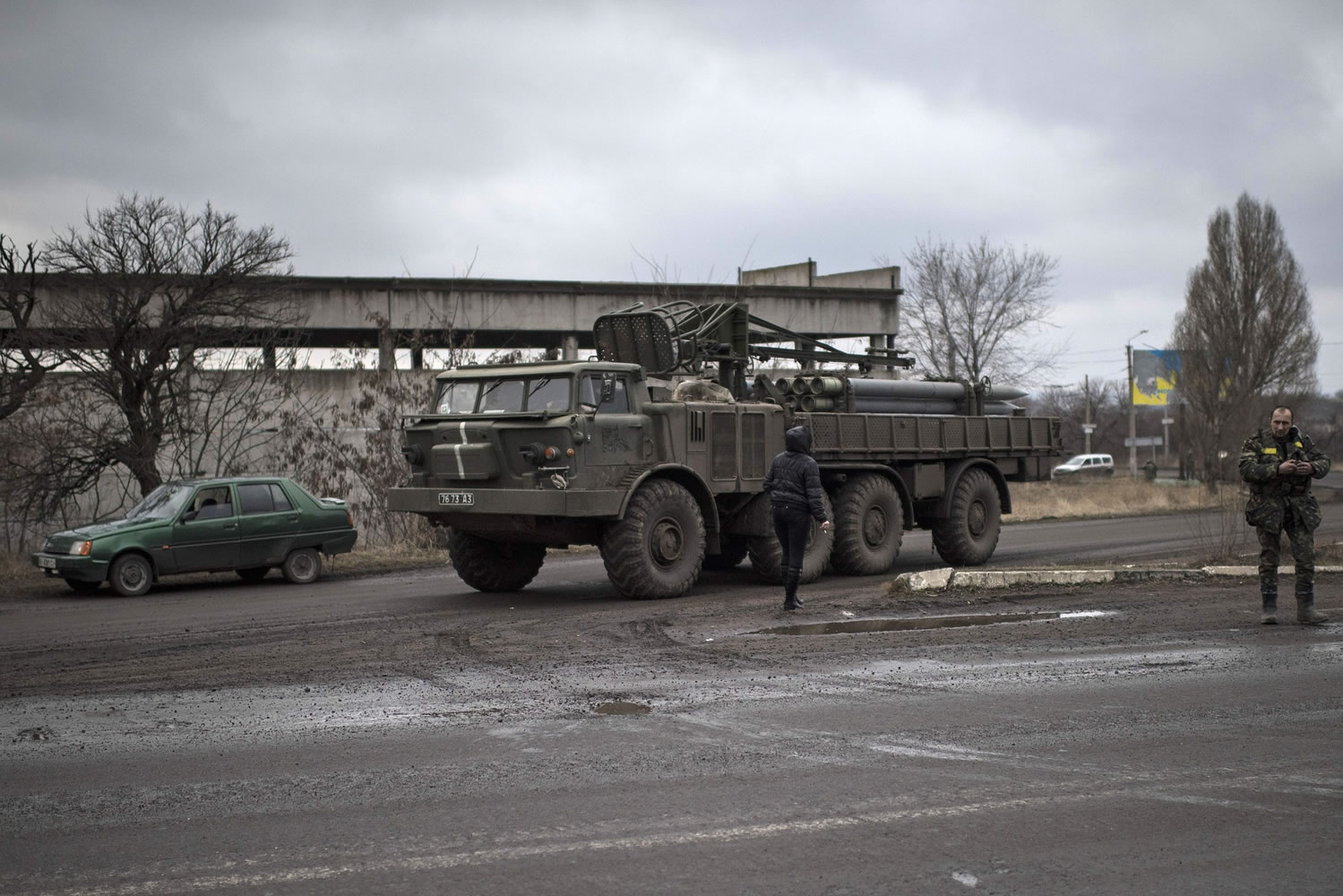 A Ukrainian military vehicle drives on a road near Artemivsk, eastern Ukraine, on Friday. Pro-Russia rebels and the Ukrainian authorities agreed Friday on a humanitarian corridor to evacuate civilians from the epicenter of fighting in eastern Ukraine as German and French leaders prepared to bring their peace plan to Moscow.