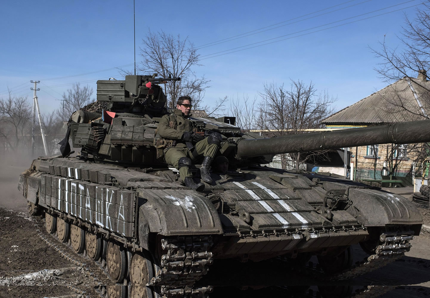 Ukrainian troops ride on a tank Tuesday near the village of Luhanske, eastern Ukraine.
