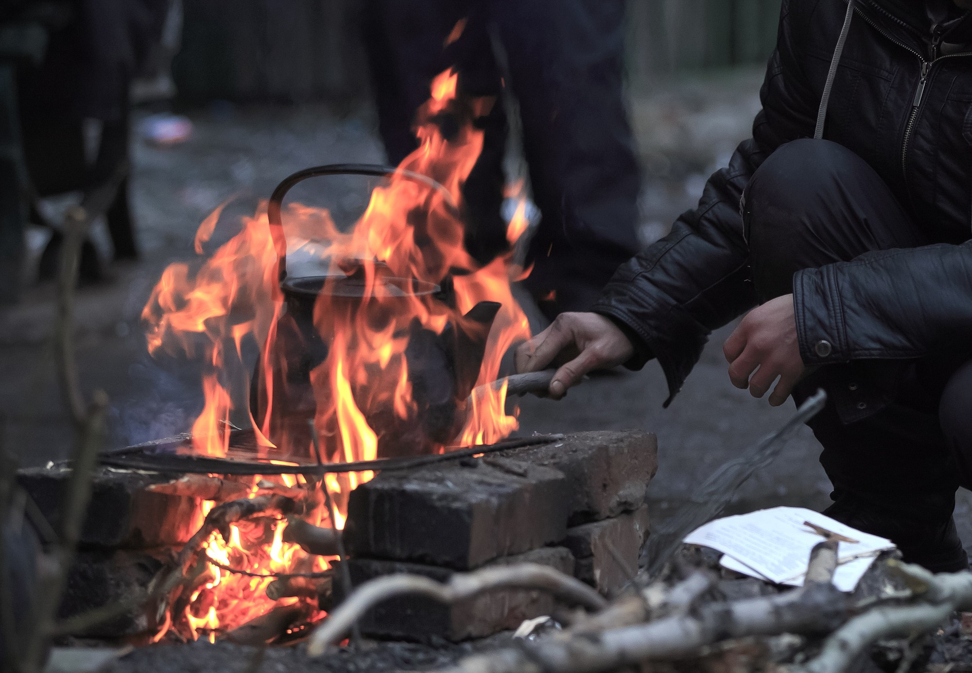 A man boils water for tea outside a damaged apartment building, disconnected from cooking gas and electricity, in Debaltseve, Ukraine, on Thursday.