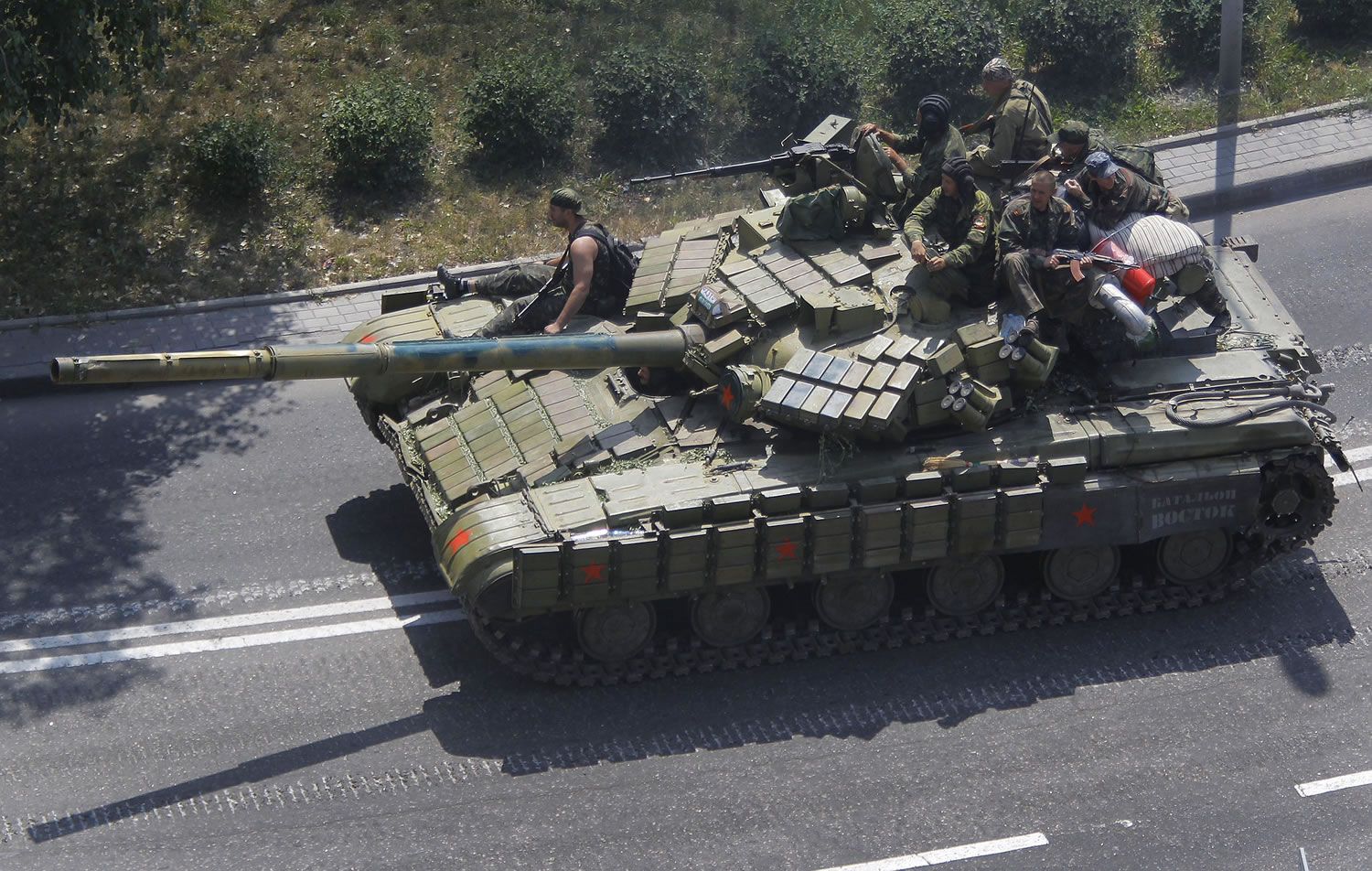 Pro-Russian rebels on a tank drive on a road in Donetsk, eastern Ukraine on Sunday.