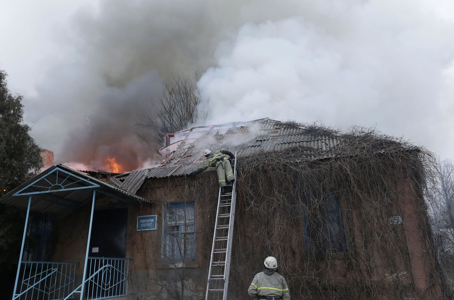Firefighters try to extinguish a building on fire after shelling between Russian-backed separatists and Ukrainian government forces in Artemivsk, Ukraine, on Saturday before the cease-fire deadline.