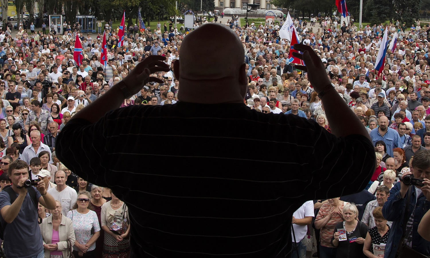People listen to a pro-Russian activist during a meeting in the city of Donetsk, eastern Ukraine, on Sunday.