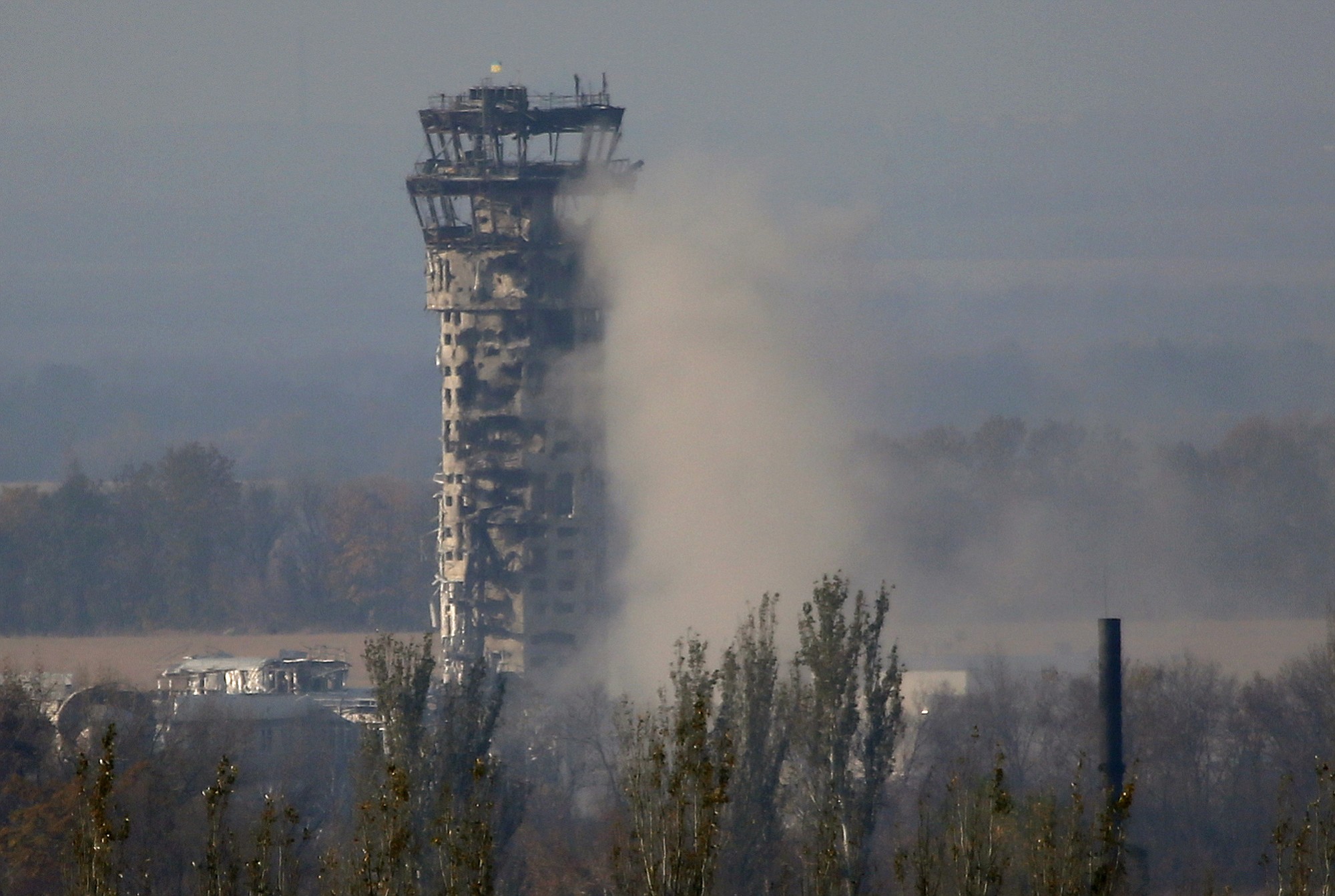 A Ukrainian flag flies atop the traffic control tower of the Donetsk airport during an artillery battle between pro-Russian rebels and Ukrainian government forces Friday in Donetsk, Ukraine.
