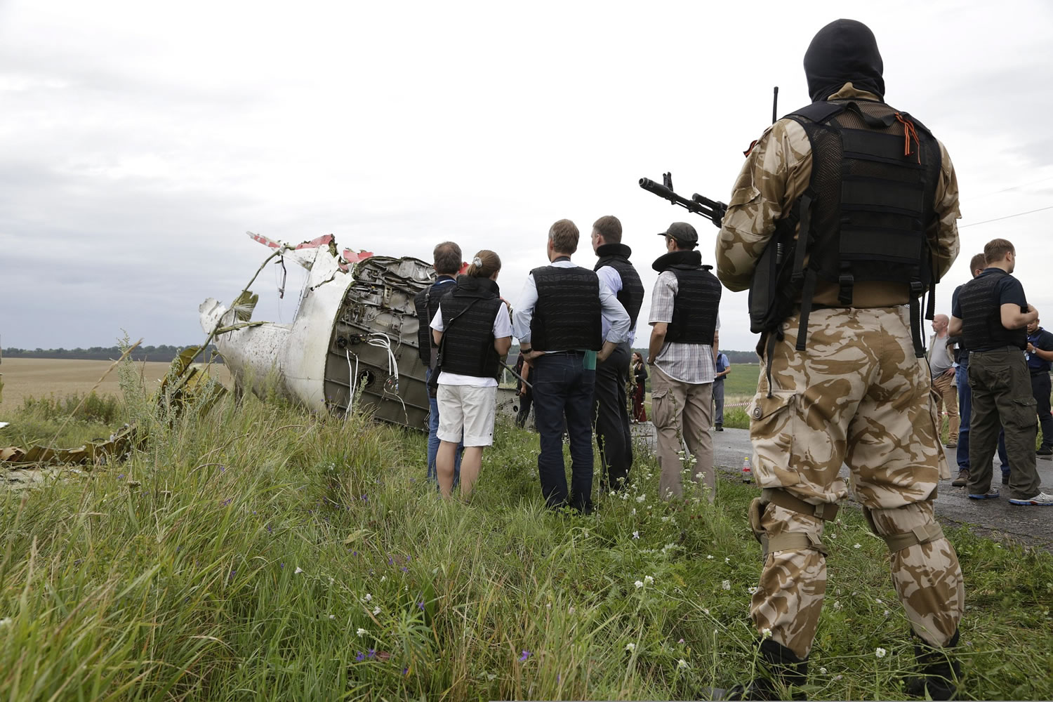 Representatives from the Organization for Security and Cooperation and Ukrainian experts arrive today at the crash site of the Malaysia Airlines jet, near the village of Hrabove.