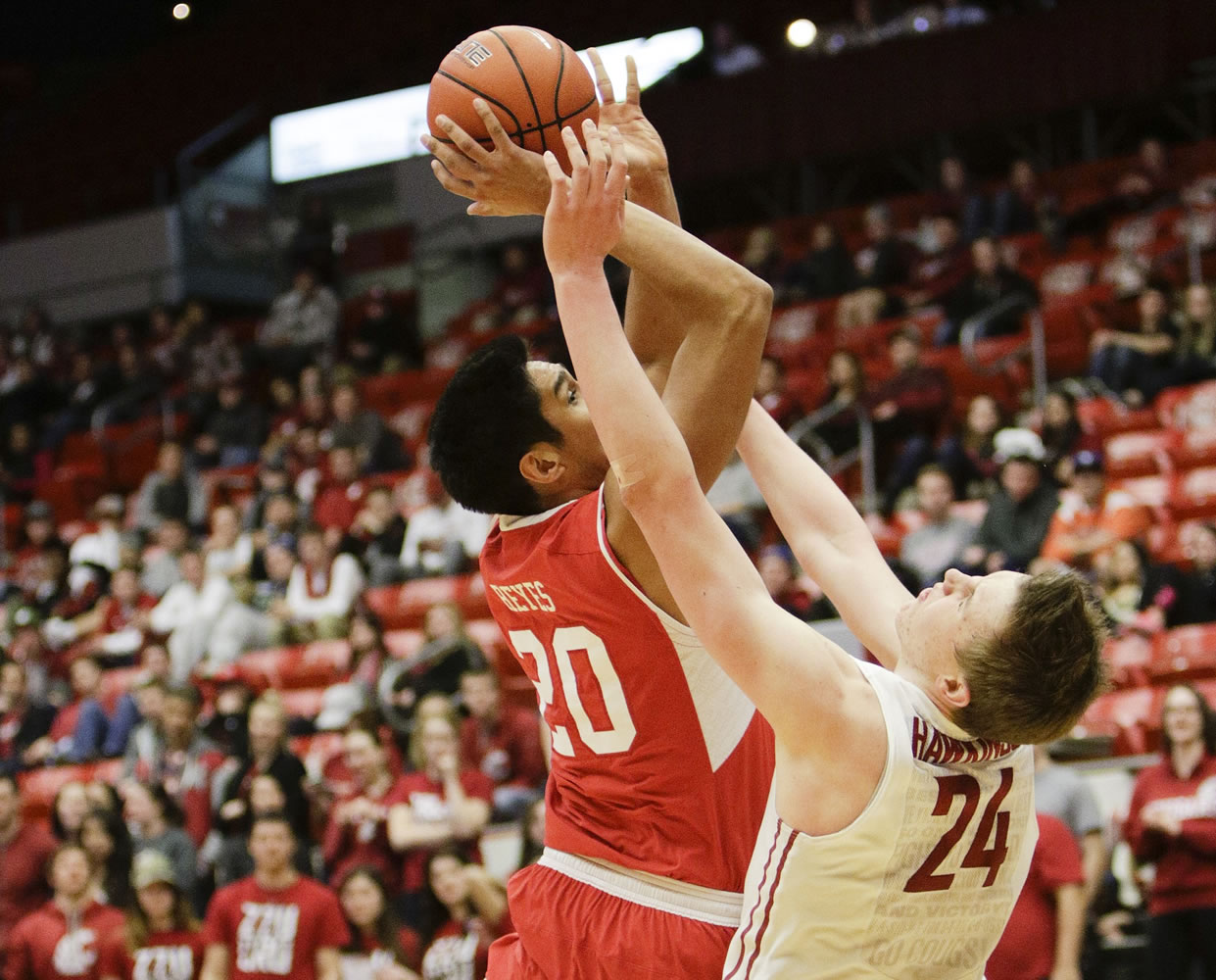 Utah forward Chris Reyes (20) puts up a shot over Washington State forward Josh Hawkinson (24) during the second half Thursday, March 5, 2015, in Pullman.