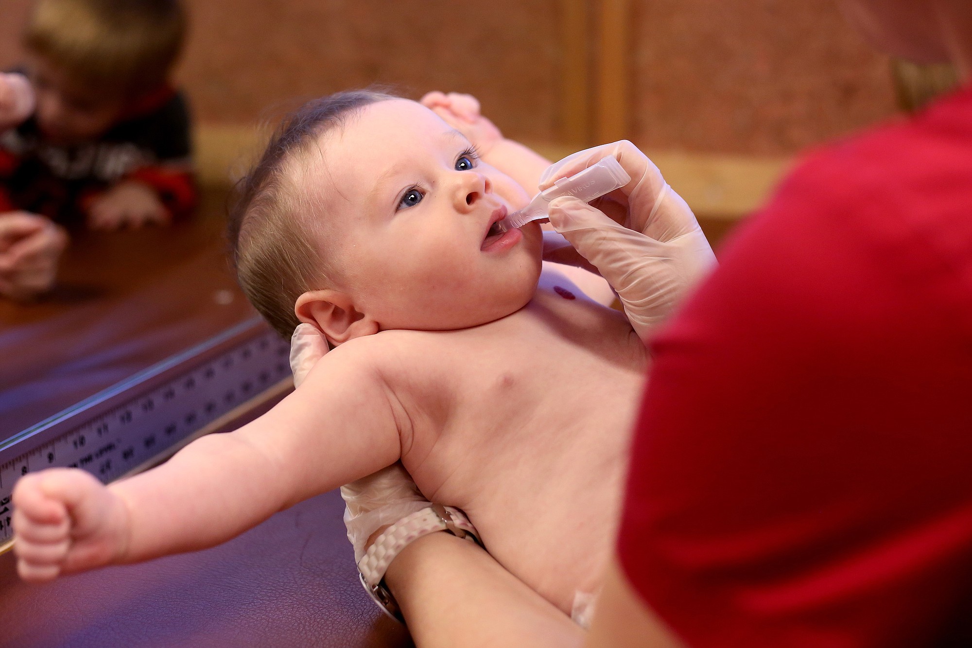 James Noland, 6 months, of Salem, receives an oral vaccine last month.