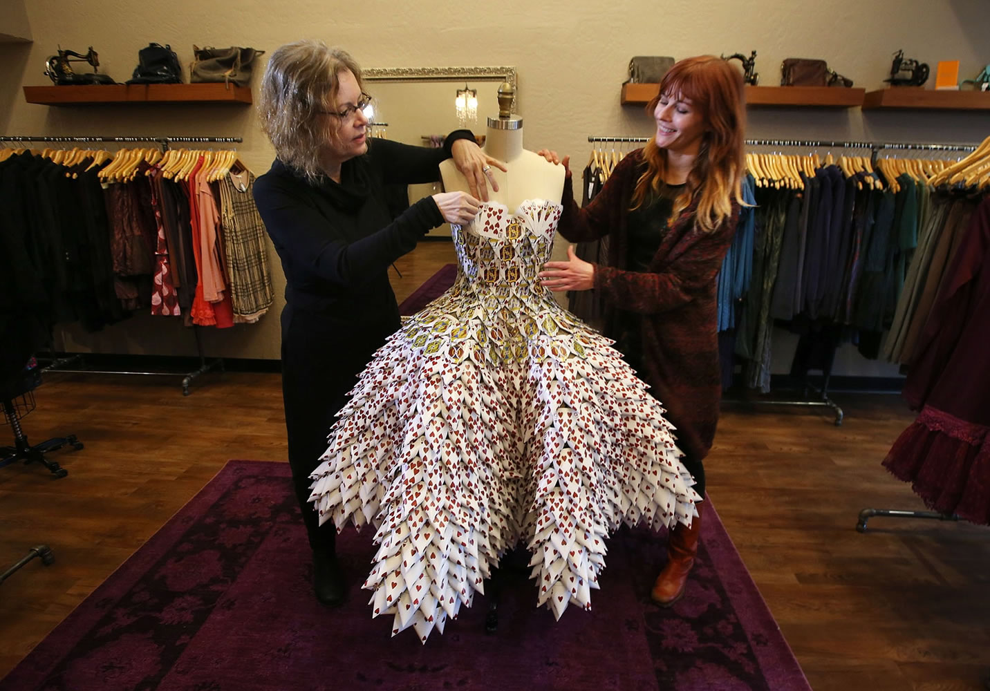 Marjorie Taylor, left, and her daughter, Amber, co-owners of Velvet Edge in Eugene, Ore., prepare a dress made from recycled casino cards for display at their boutique to celebrate Valentine's Day.