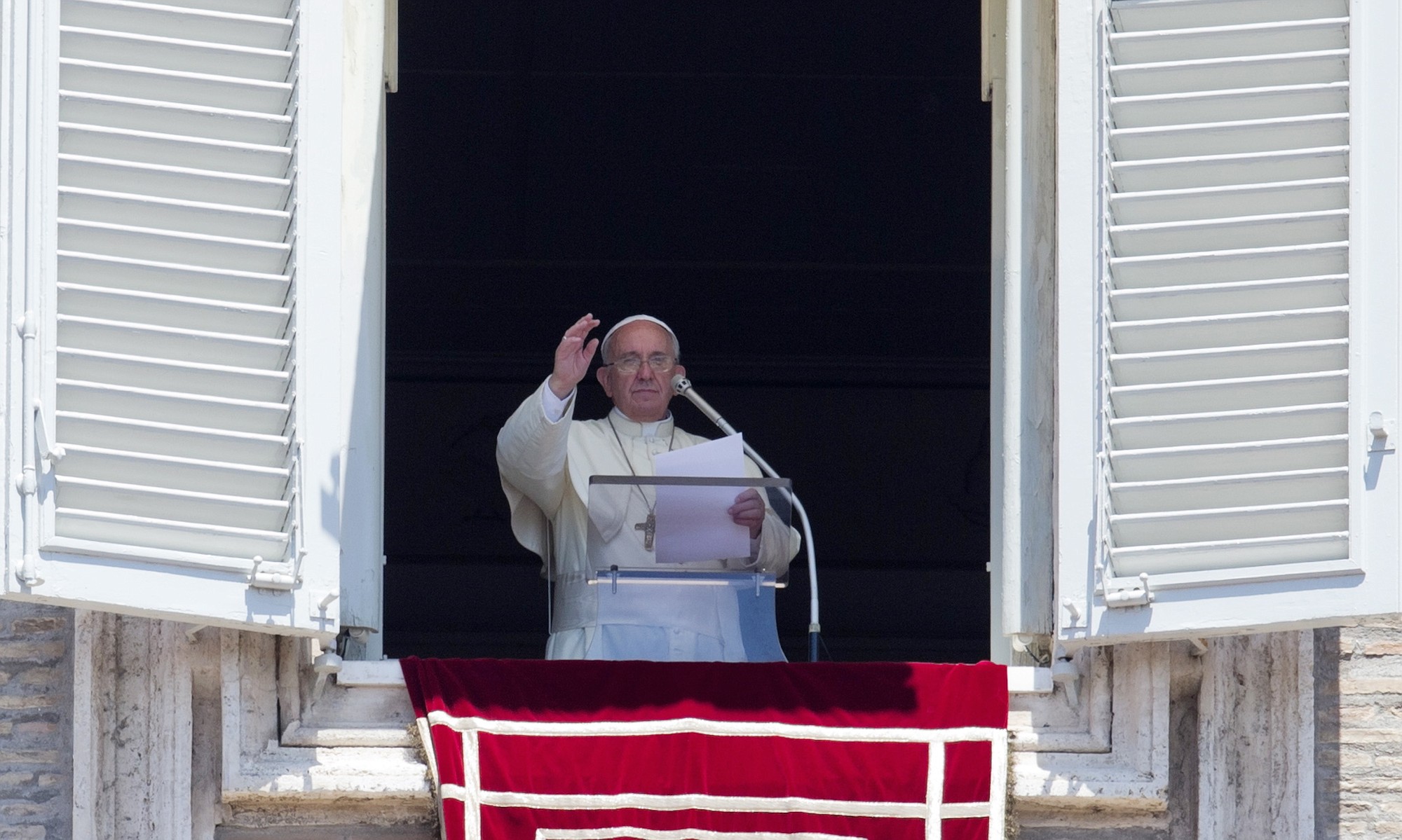 Pope Francis celebrates the Angelus noon prayer from his studio window overlooking St.