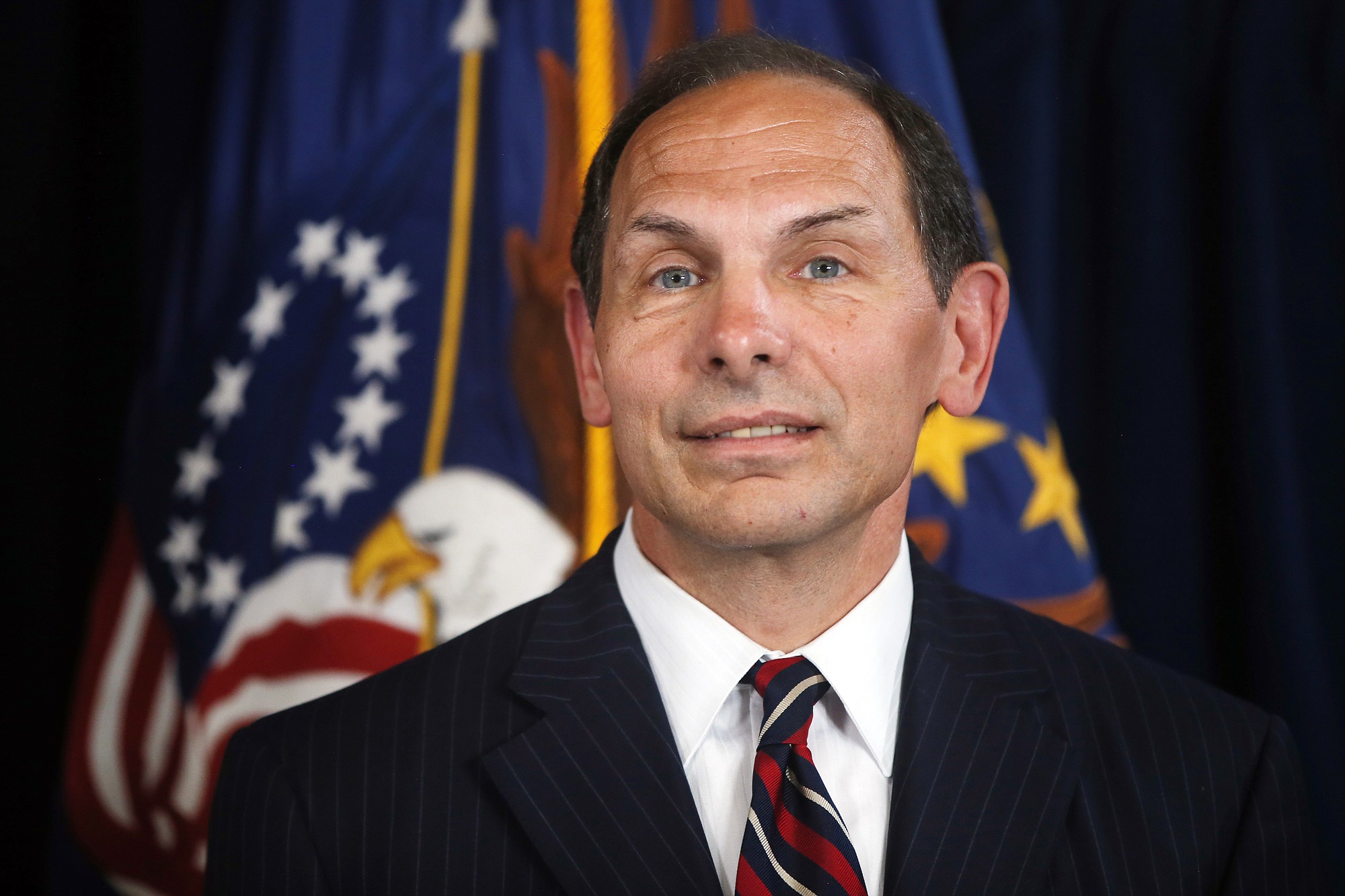 Former Procter and Gamble executive Robert McDonald, President Barack Obama's nominee as the next Veterans Affairs secretary, listens as Obama makes a statement at the Department of Veterans Affairs on June 30.