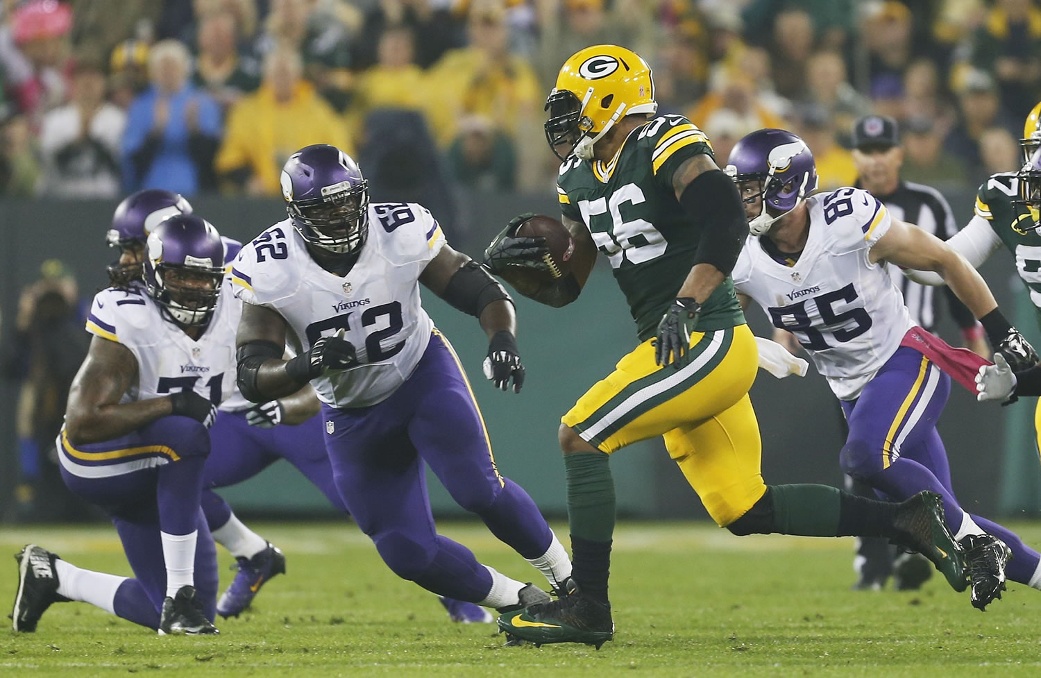 Green Bay Packers' Julius Peppers runs back an interception 49-yards for a touchdown during the first half  against the Minnesota Vikings on Thursday, Oct. 2, 2014, in Green Bay, Wis.
