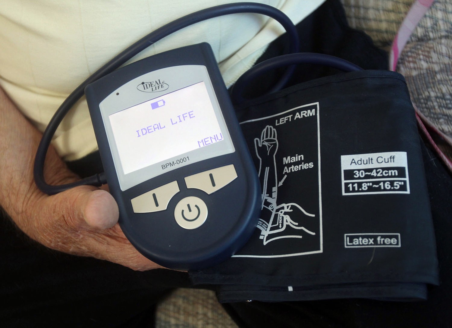 Ken Dalton holds a blood pressure machine.