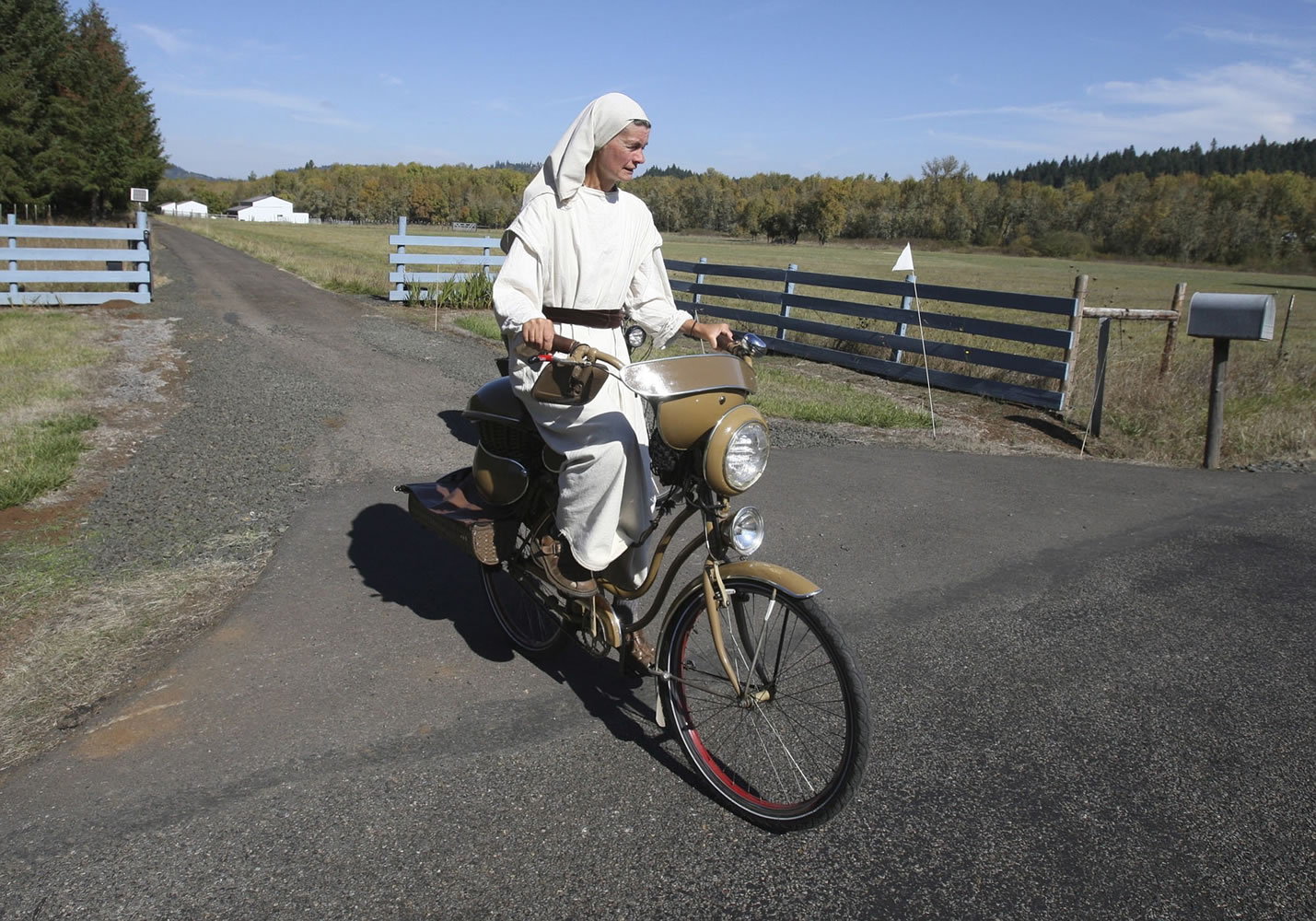 Photos by Collin Andrew/The Register-Guard
Cheryl Cutler rides a bike she built herself from old bike parts, recycled mobile home siding and kitchen pots near Lorane, Ore. Cheryl and her husband, Eli, have chosen to live a simple life as they caretake property in rural Lane County.