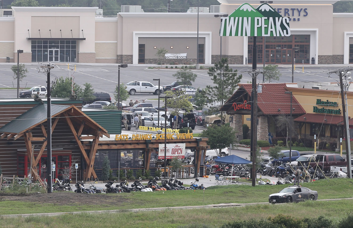 Law enforcement continue to investigate the motorcycle gang related shooting at the Twin Peaks restaurant Monday in Waco, Texas, where 9 were killed Sunday and over a dozen injured.