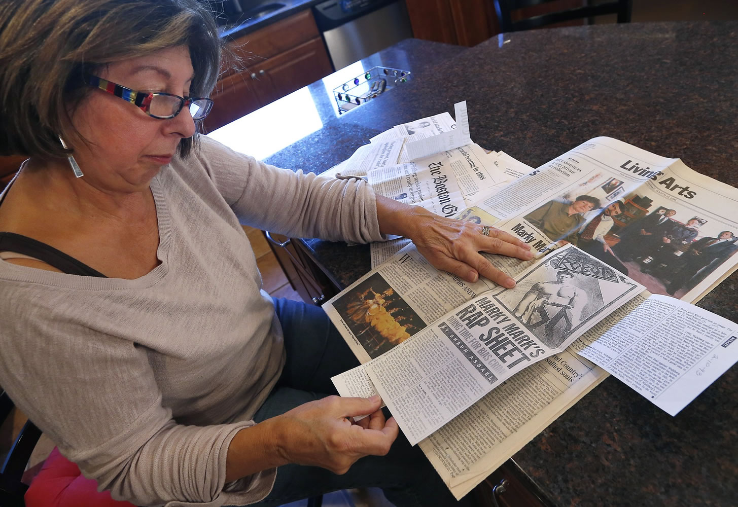 Mary Belmonte reviews newspaper clippings she had collected about Mark Wahlberg at her home in Westwood, Mass.